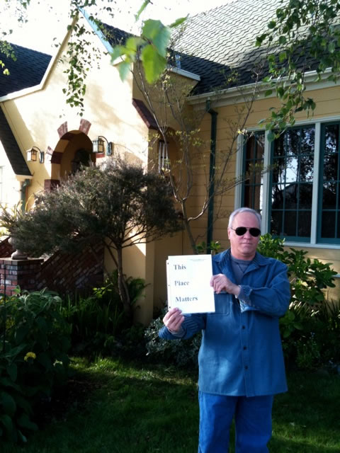 Jim Test holding "This place matters" sign